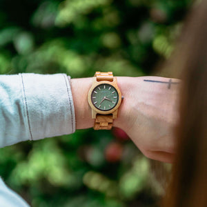 Light wood custom wood watch worn on wrist with green dial – engraved wooden watch handcrafted from natural materials
