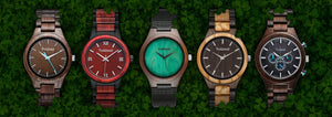 TruWood wooden watches displayed on green leaf background – natural wood watch collection featuring unique eco-friendly designs.